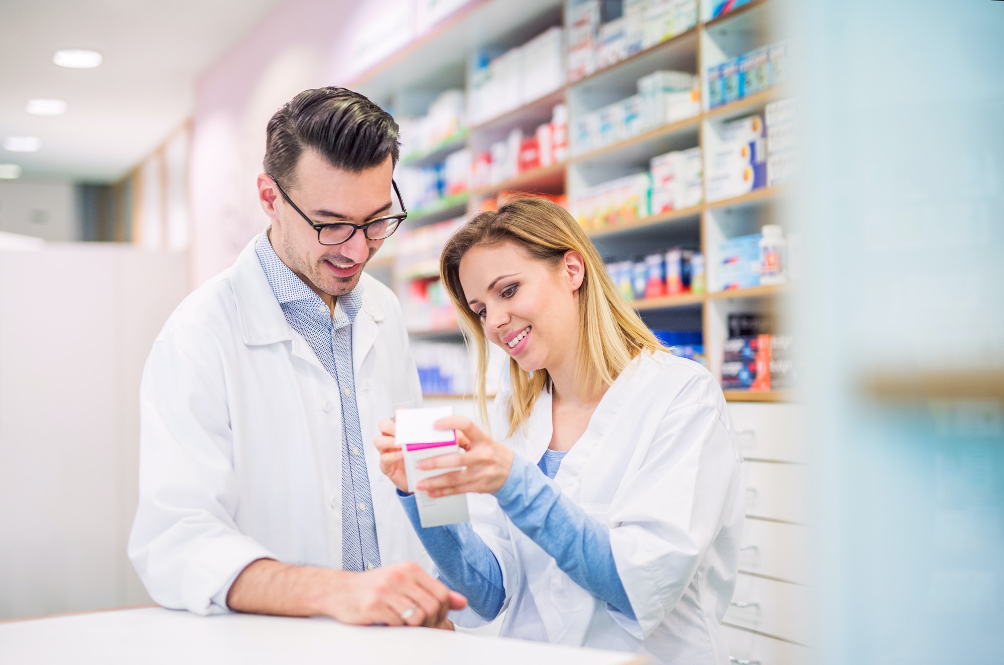 two-pharmacists-working-in-a-drugstore-.jpg