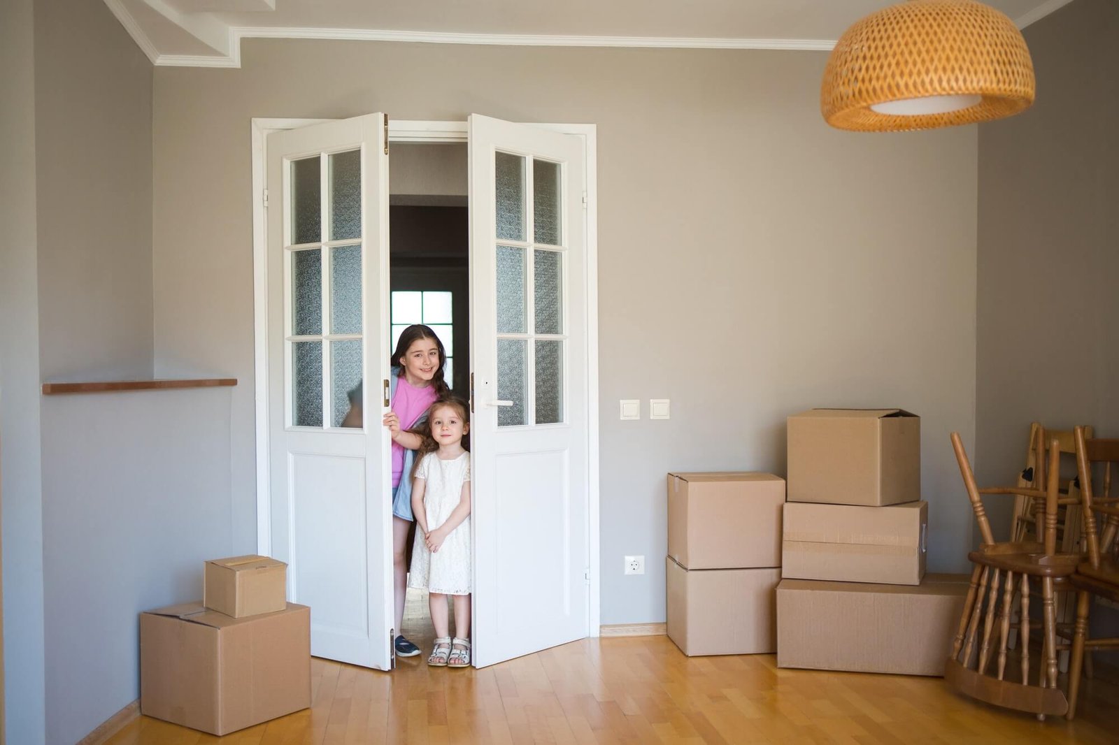 children-look-into-its-new-home-moving-to-apartment-boxes-in-house-1-1.jpg