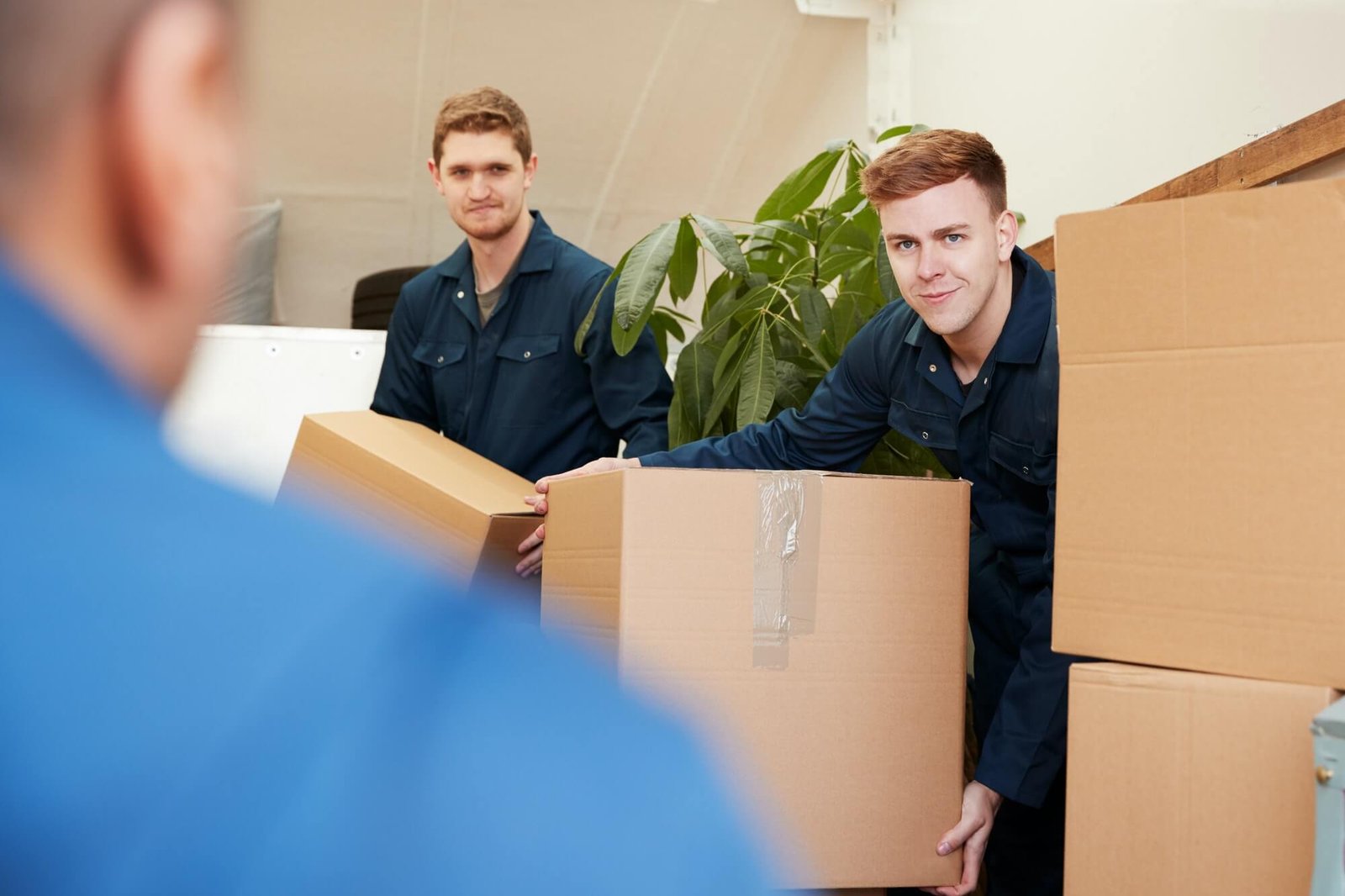 removal-company-workers-unloading-furniture-and-boxes-from-truck-into-new-home-on-moving-day-1.jpg